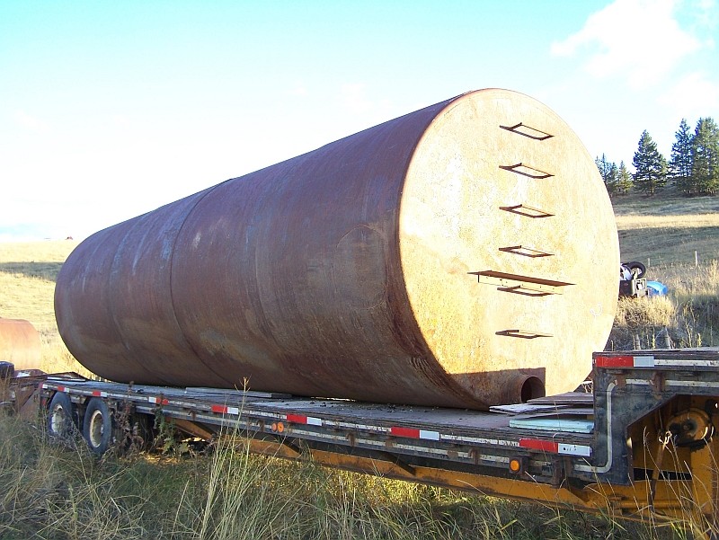 Used 9500 Gallon Steel Water Tank. Access Ladder on End. 10 in. Grooved Discharge at Bottom.