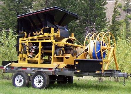 30 inch dia. x 78 inch long portable trommel. With feed hopper and sluice box. Tandem axle trailer and power generator.